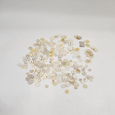 VINTAGE PILE OF MULTI TONED WHITE BUTTONS