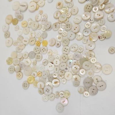 VINTAGE PILE OF MULTI TONED WHITE BUTTONS