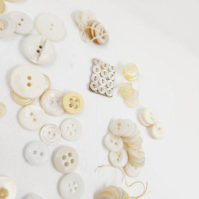 VINTAGE PILE OF MULTI TONED WHITE BUTTONS