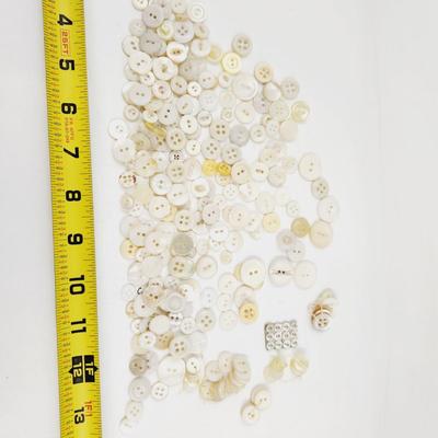 VINTAGE PILE OF MULTI TONED WHITE BUTTONS