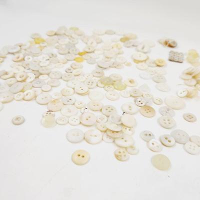 VINTAGE PILE OF MULTI TONED WHITE BUTTONS