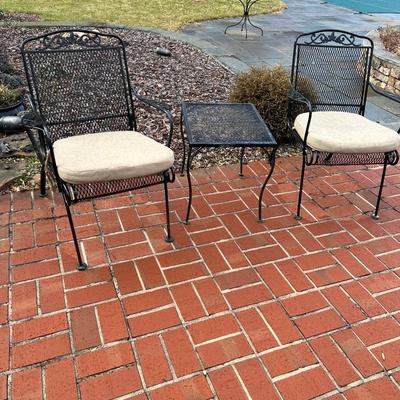 2 patio chairs with beige bottom sunbrella cushions w/ side table
