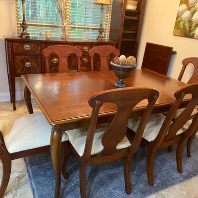 American Drew solid wood dining table with one leaf and six beige upholstered chairs