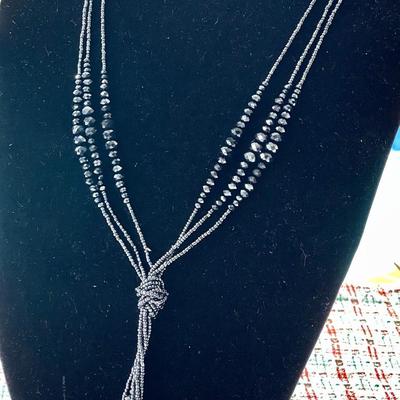 LOT 119  COSTUME JEWELRY TRIPLE STANDS OF OPERA LENGTH BEADS KNOTTED DROP