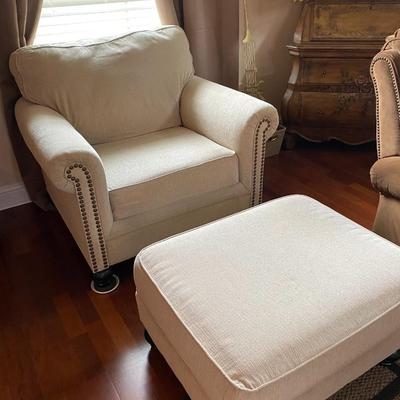 Fabric cream-colored upholstered chair with ottoman