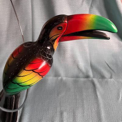 COLORFUL TOUCAN BIRD ON ROUND PERCH