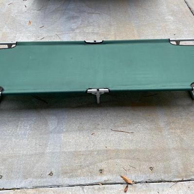 Green aluminum folding camping cot