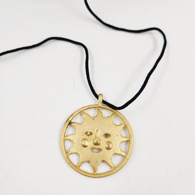 LARGE GOLD TONED SUN PENDANT W/ CLOTH NECKLACE