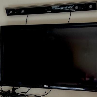 LOT 127  LG FLAT SCREEN WALL MOUNTED TV 2011 W/SOUND BAR & WOOFER