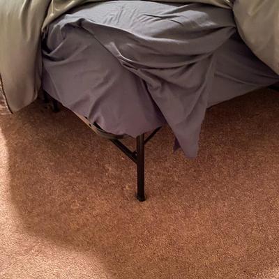 King-size bed with off-white upholstered nail-head headboard