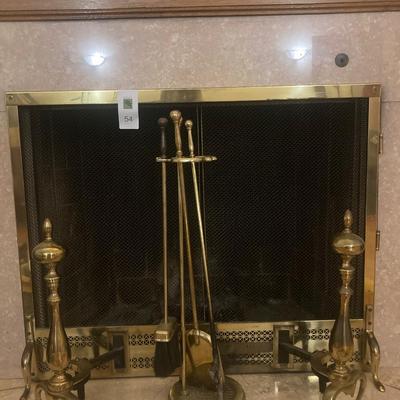 Brass fireplace screen with matching andirons and fireplace tools