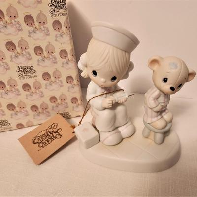 Lot #97  Precious Moments Figure "Love Cureth All Things" - has box/tags