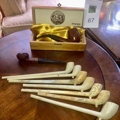 Lot of smoking pipes with two wooden pipe stands