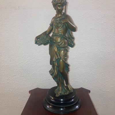 Patinated metal sculpture of a woman