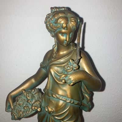 Patinated metal sculpture of a woman