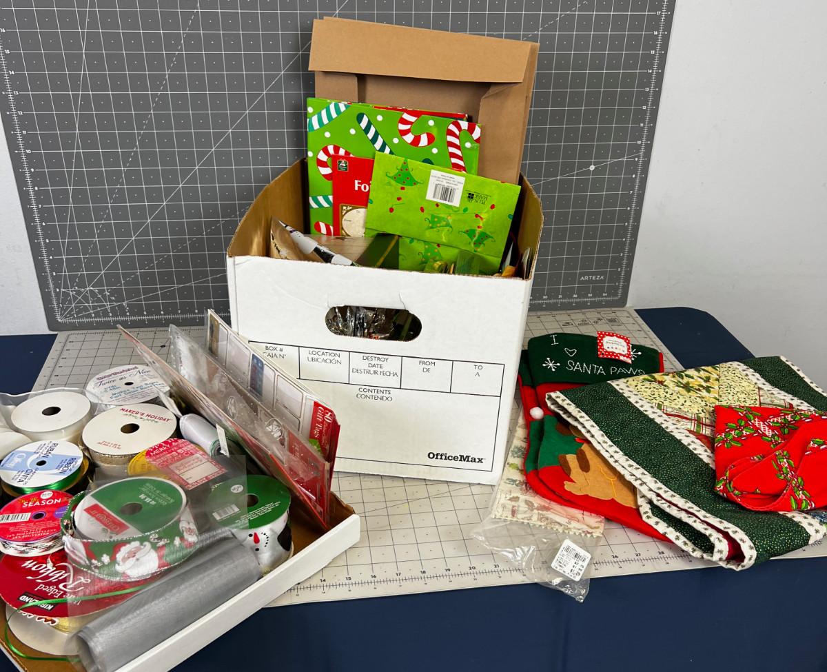 Box of Holiday Items Wrap, linens, Cards, Stocking