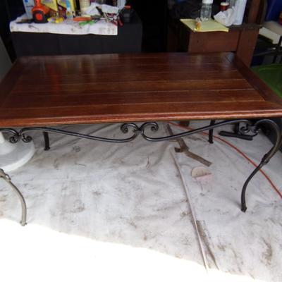WROUGHT IRON TABLE WITH WOOD TOP.