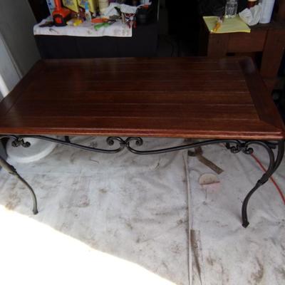 WROUGHT IRON TABLE WITH WOOD TOP.