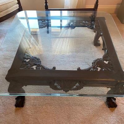 Beveled square heavy glass coffee table with carved wooden base