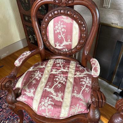 LOT 11. PAIR OF ORNATELY CARVED RED TEAK ARM CHAIRS