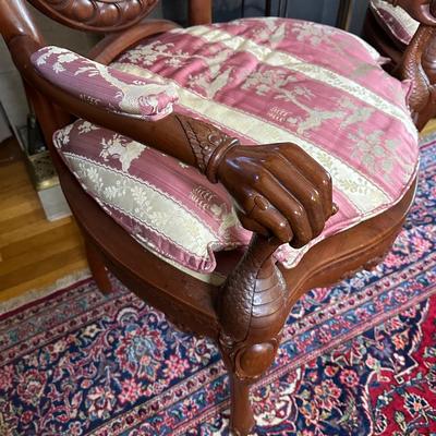 LOT 11. PAIR OF ORNATELY CARVED RED TEAK ARM CHAIRS