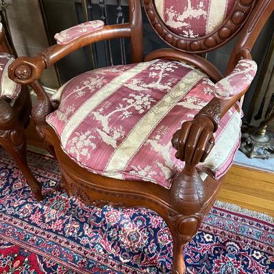LOT 11. PAIR OF ORNATELY CARVED RED TEAK ARM CHAIRS