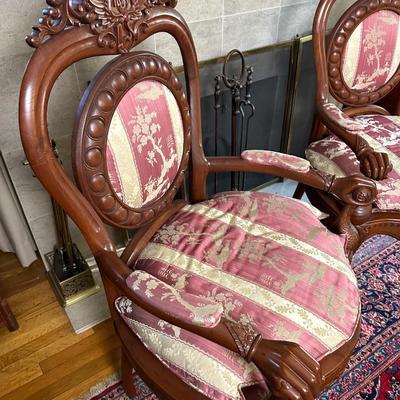 LOT 11. PAIR OF ORNATELY CARVED RED TEAK ARM CHAIRS