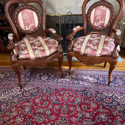 LOT 11. PAIR OF ORNATELY CARVED RED TEAK ARM CHAIRS