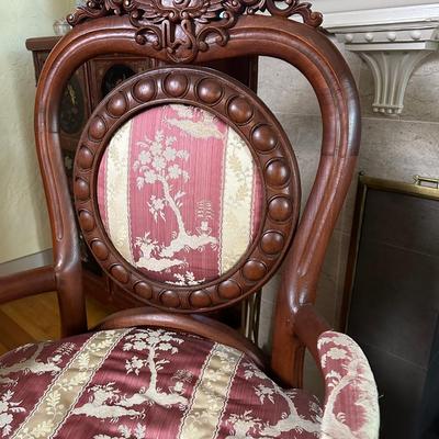 LOT 11. PAIR OF ORNATELY CARVED RED TEAK ARM CHAIRS