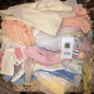 Lot of vintage baby clothes, baby shoes and toddler rocking chair