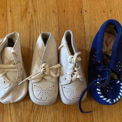 Lot of vintage baby clothes, baby shoes and toddler rocking chair
