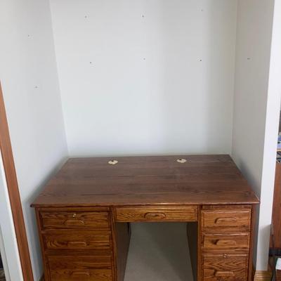 Large wood desk with a Burl wood vase