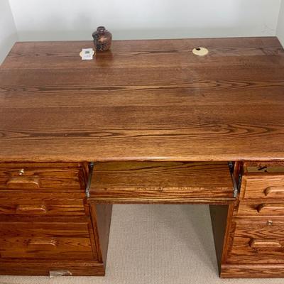 Large wood desk with a Burl wood vase
