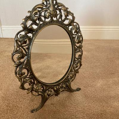 Ornate vintage metal vanity mirror.