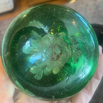Vintage Green Glass paperweight with silver flowers suspended inside on carved wood stand