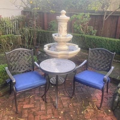 Pair of metal patio chairs with table