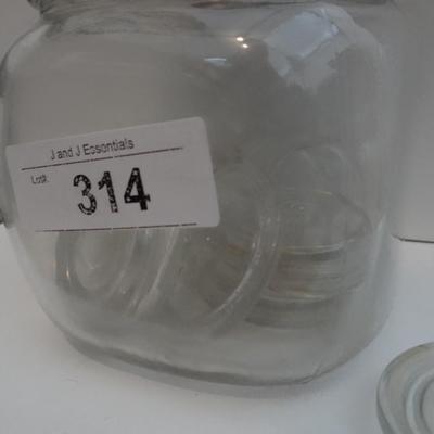 VINTAGE GLASS JAR CONTAINING GLASS CANNING LIDS