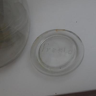 VINTAGE GLASS JAR CONTAINING GLASS CANNING LIDS