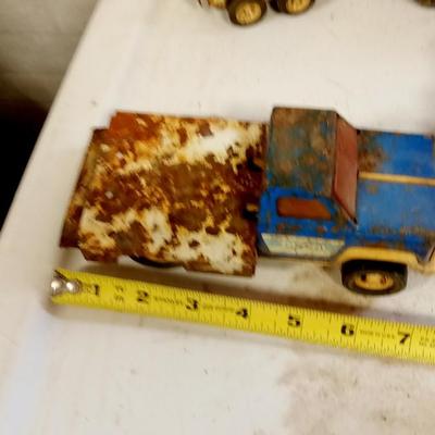 LOT 150   FOUR OLD TOY TRUCKS AND ONE TRAILER