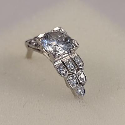 Platinum Diamond Ring with Center 1.12 Carat Diamond and One Dozen Diamond Chips Set in Sheild Design Band