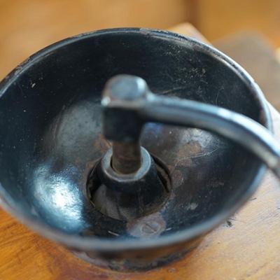 ANTIQUE CRANK TABLE TOP COFFEE GRINDER W/ CAST IRON CRANK/ PRESSED DESIGN ON THE BEAN COMPARTMENT.