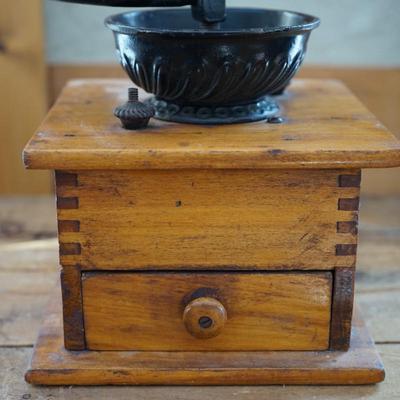 ANTIQUE CRANK TABLE TOP COFFEE GRINDER W/ CAST IRON CRANK/ PRESSED DESIGN ON THE BEAN COMPARTMENT.