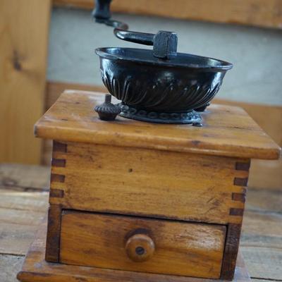 ANTIQUE CRANK TABLE TOP COFFEE GRINDER W/ CAST IRON CRANK/ PRESSED DESIGN ON THE BEAN COMPARTMENT.
