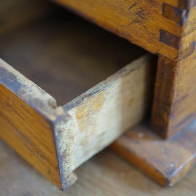 ANTIQUE CRANK TABLE TOP COFFEE GRINDER W/ CAST IRON CRANK/ PRESSED DESIGN ON THE BEAN COMPARTMENT.