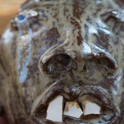 HAND CRAFTED FOLK ART "UGLY " FACE HANDLED JUG SIGNED SKINNER DATED 2005
