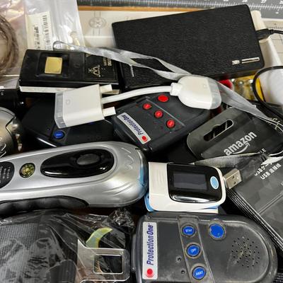 Tray of Electrical things; Cables, juice pack, garage Door openers, Alarms