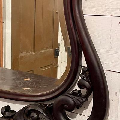 Antique dresser with ornate beveled mirror