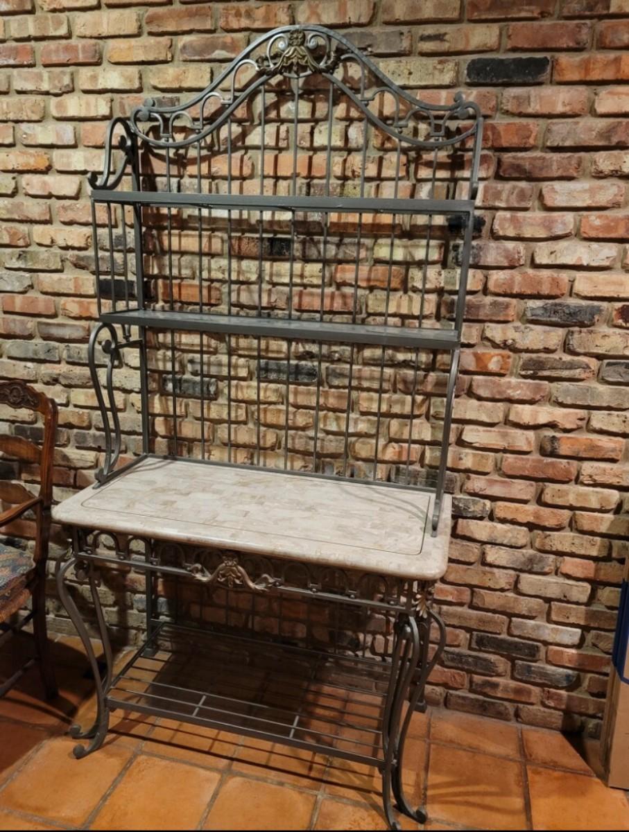 Wrought iron bakers rack with glass shelves. 84” tall, 40” wide, 20