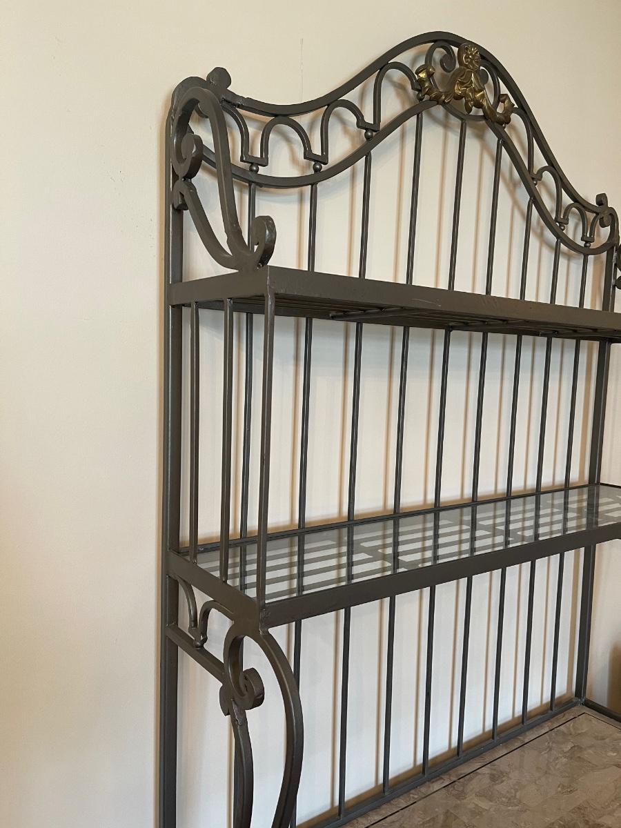 Wrought iron bakers rack with glass shelves. 84” tall, 40” wide, 20