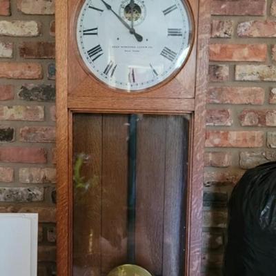 Self-winding clock. Large brass pendulum. 63â€ high, 19â€ wide, 7â€ deep.